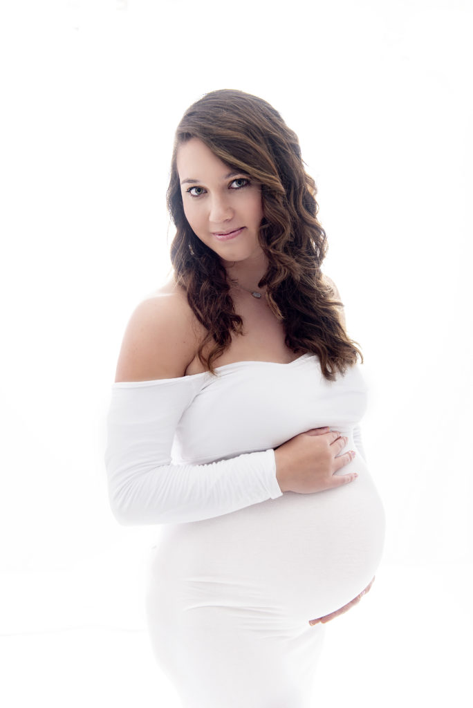 beautiful maternity mom wearing white gown
